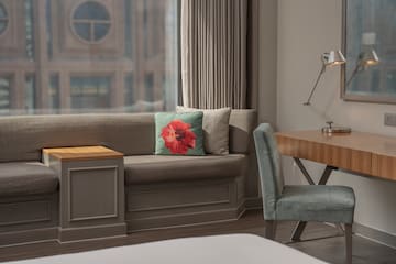 a couch with a pillow and a chair in a room