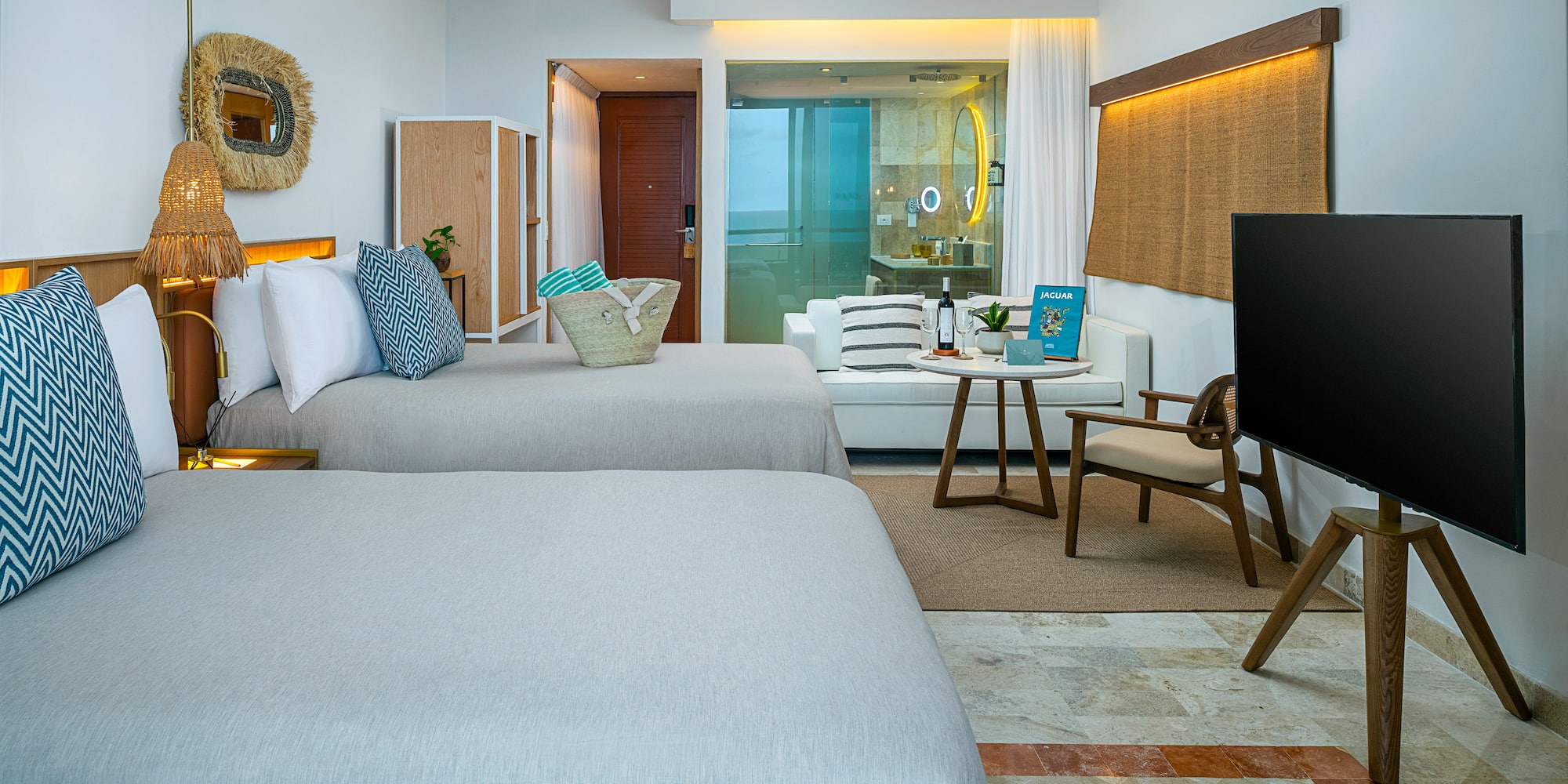 a room with two beds and a television