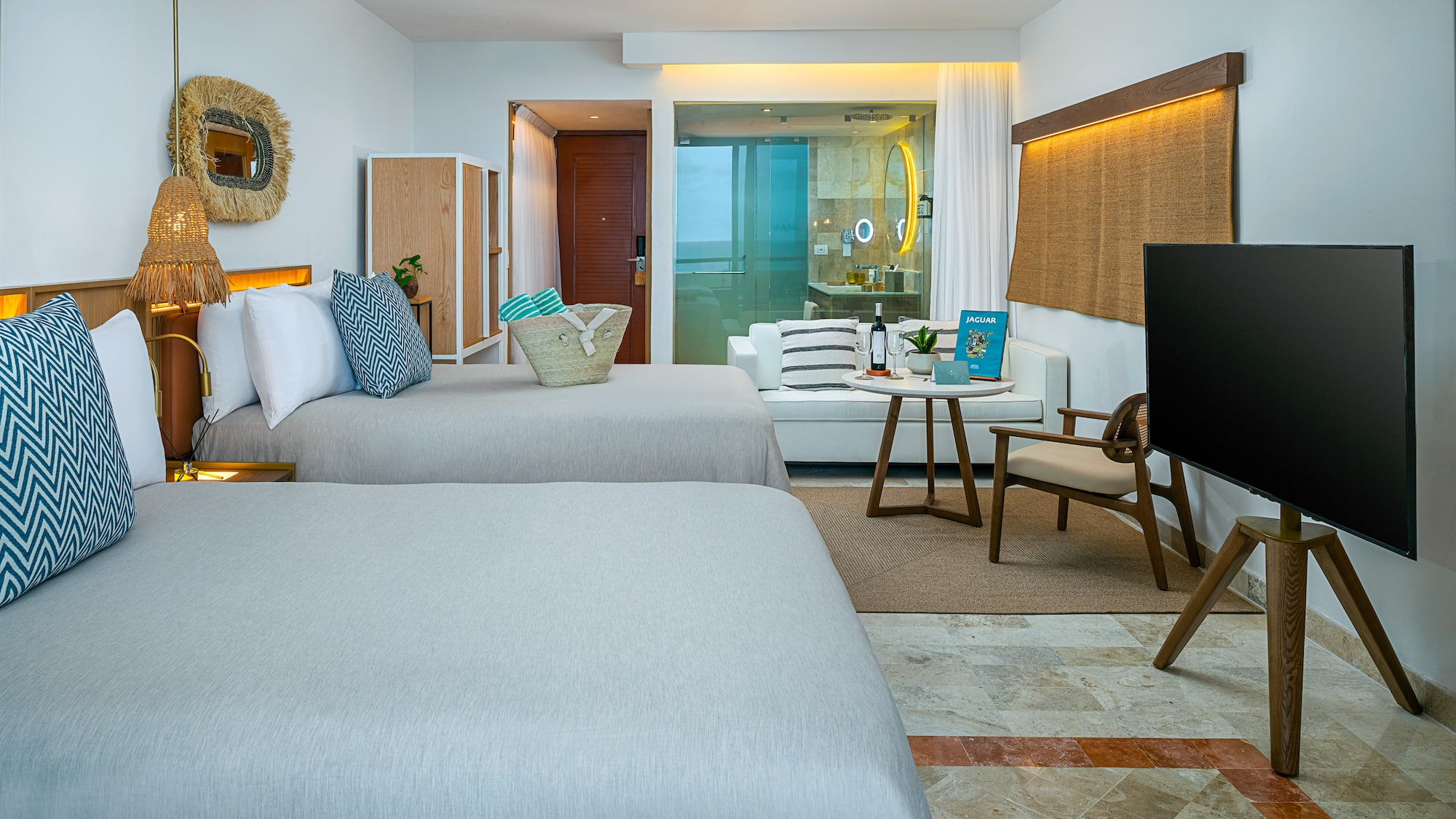 a room with two beds and a television