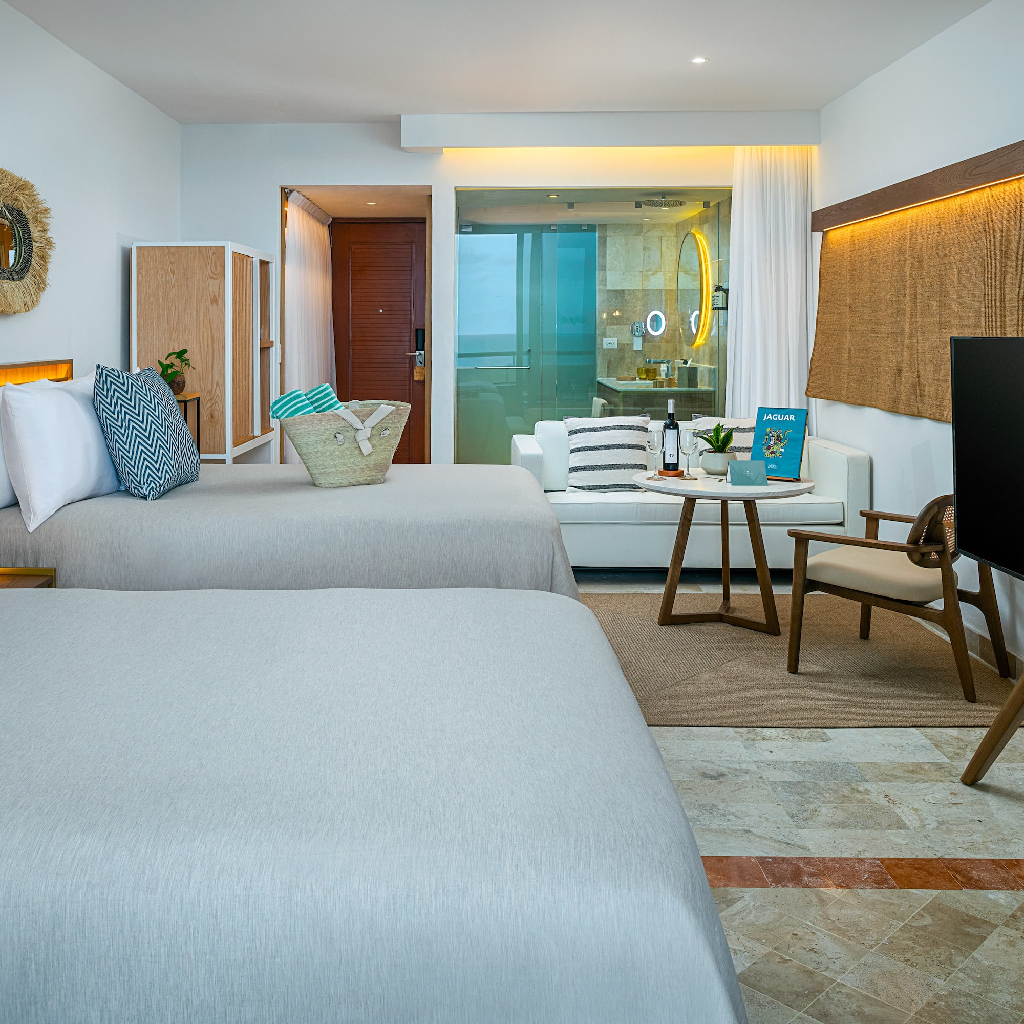 a room with two beds and a television