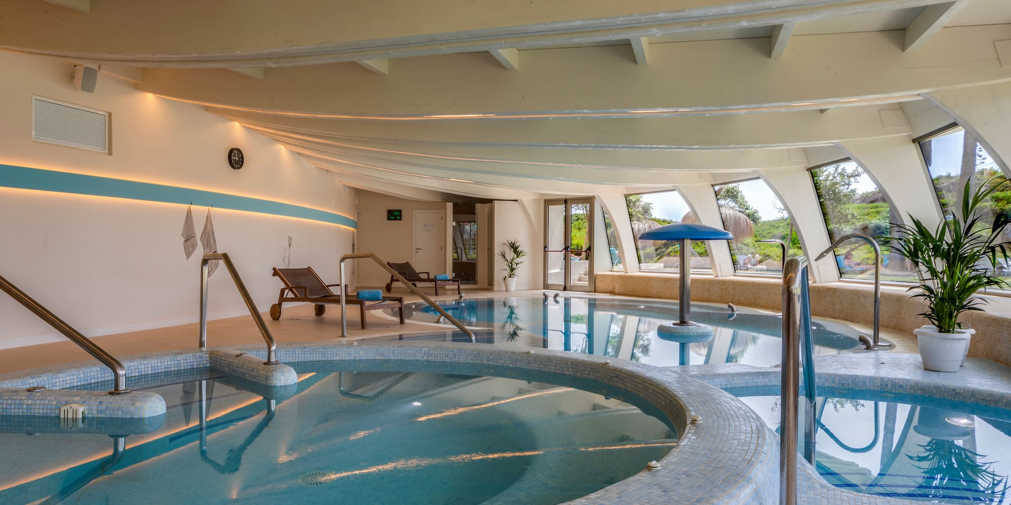 a indoor pool with a large tub