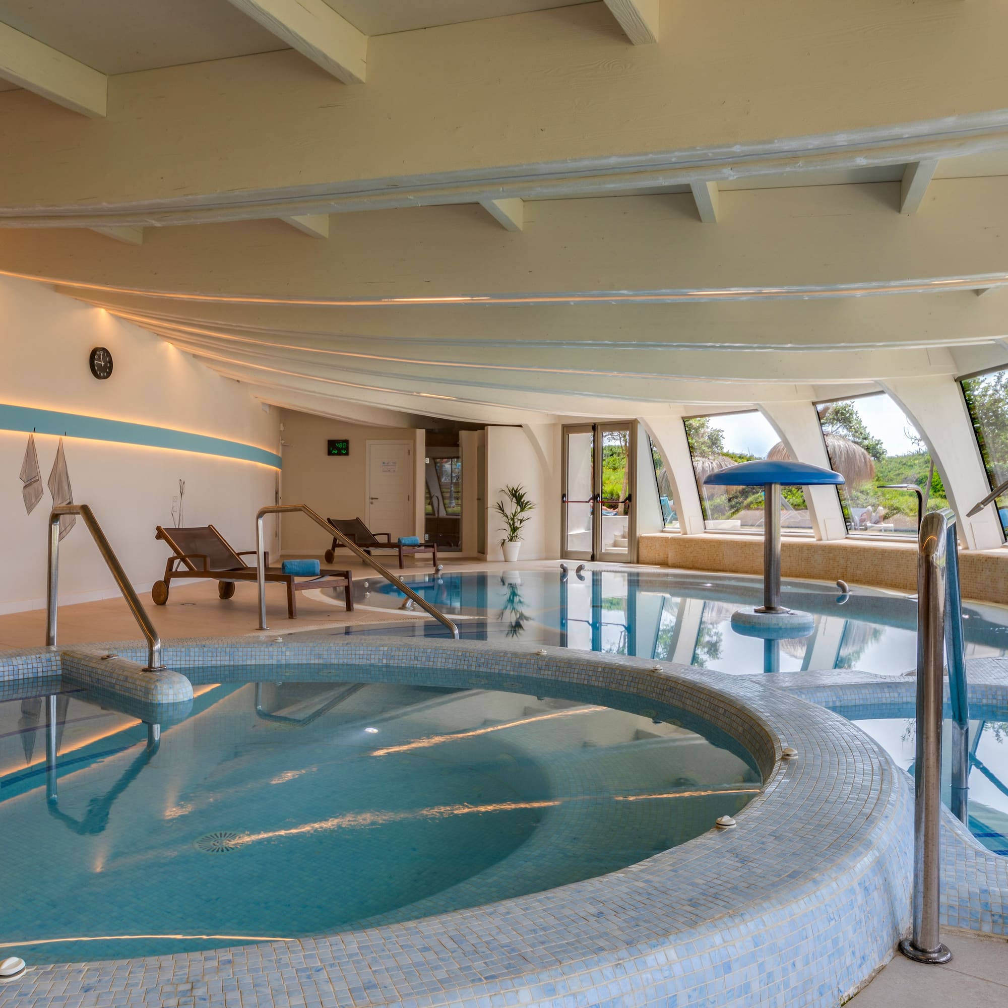 a indoor pool with a large tub