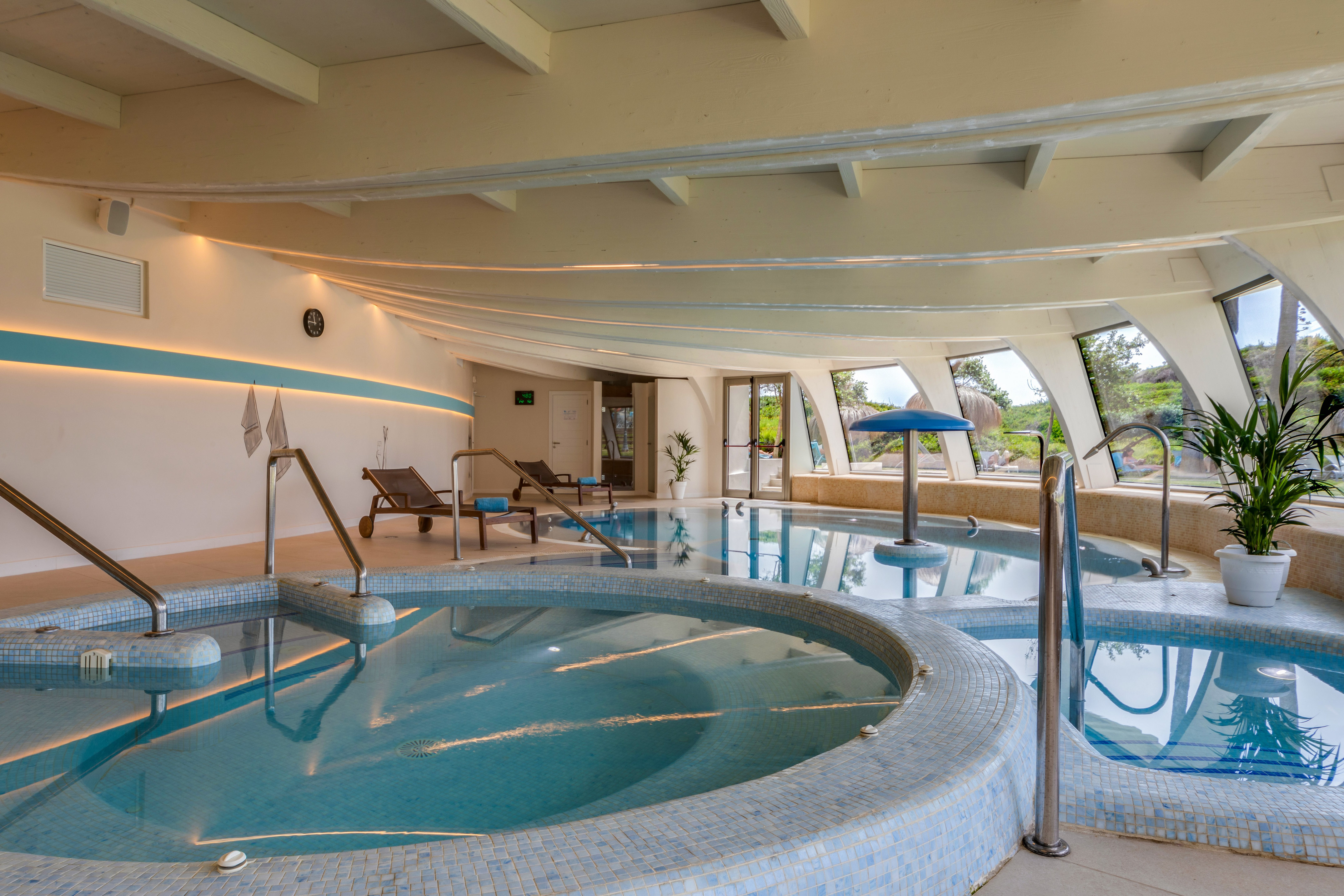 a indoor pool with a large tub