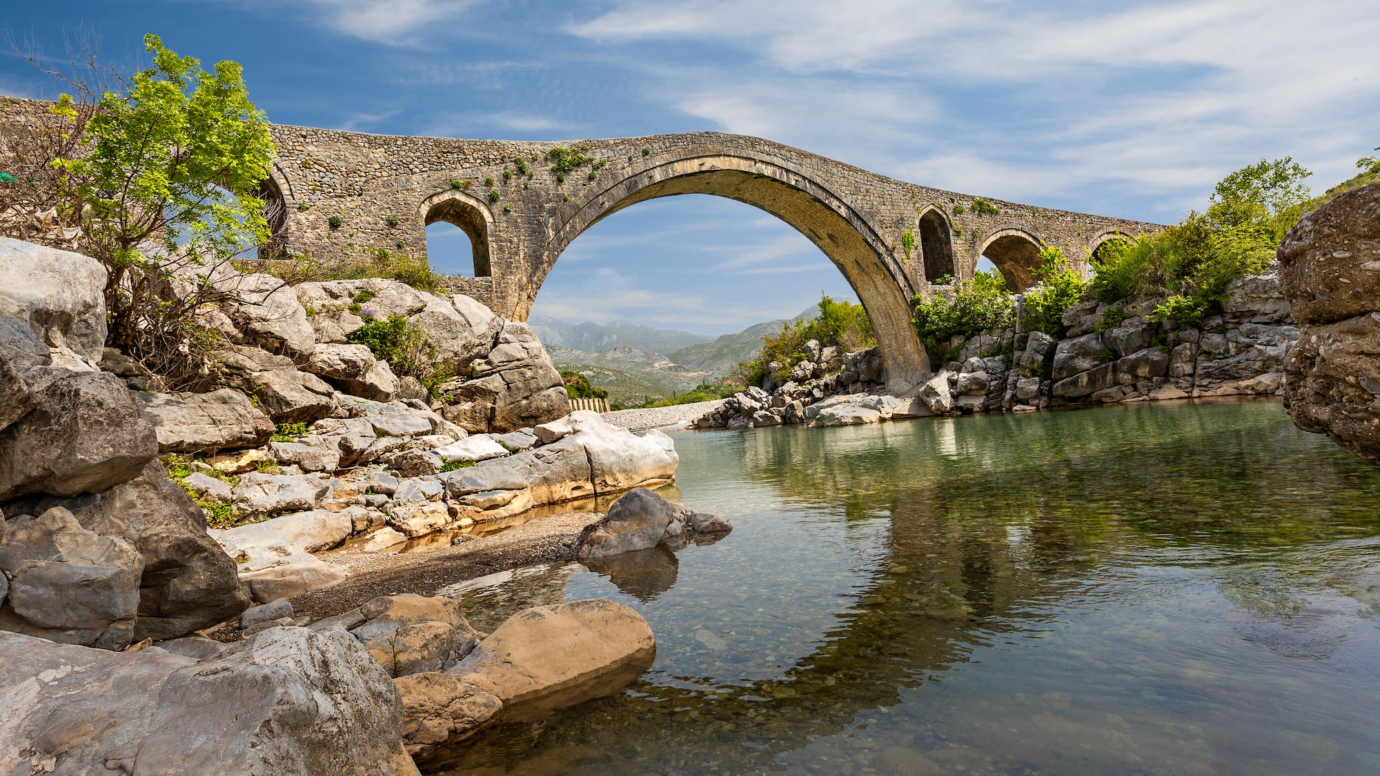 a stone bridge over a river