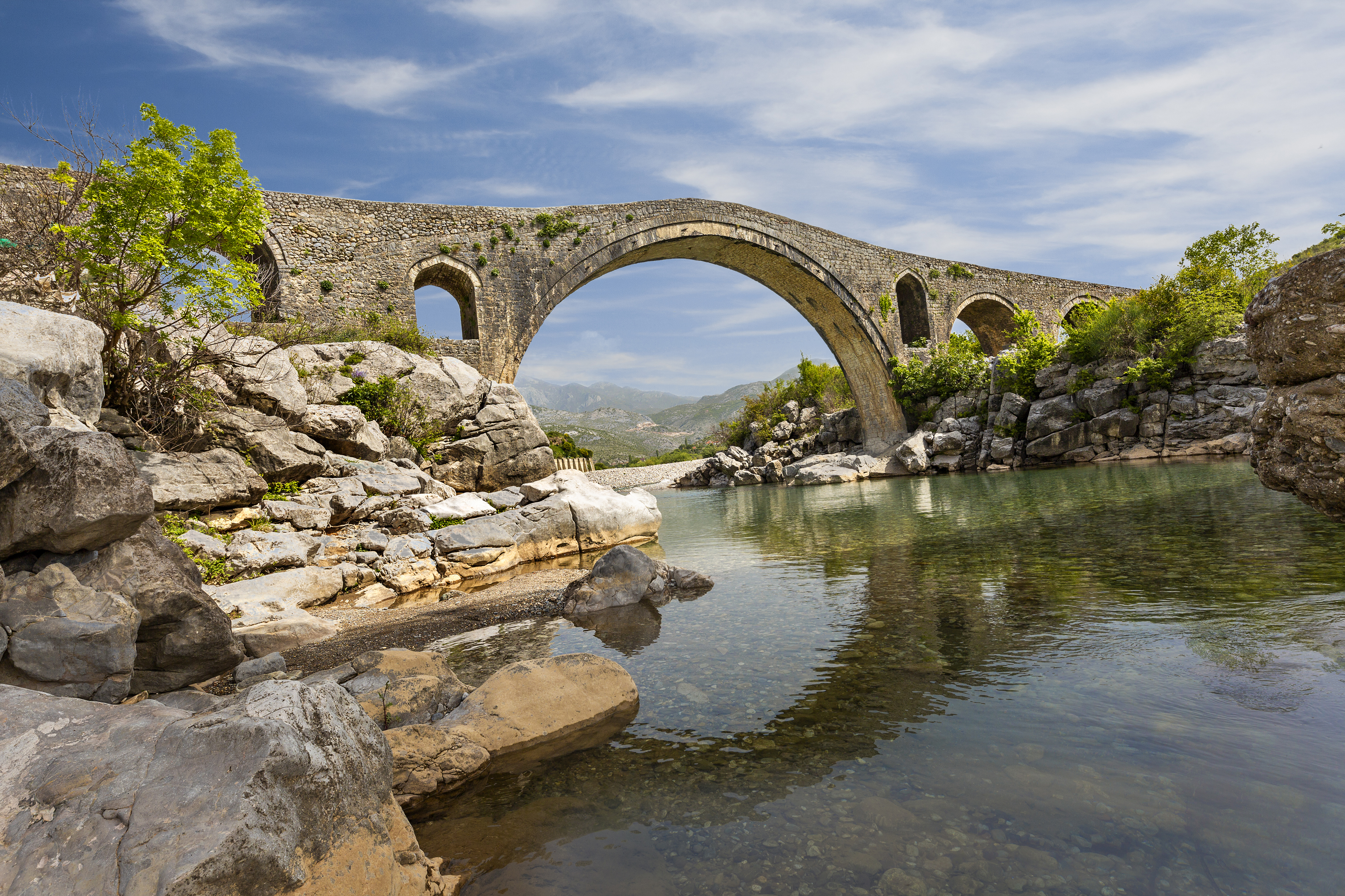 a stone bridge over a river