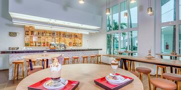 a room with tables and chairs and a bar