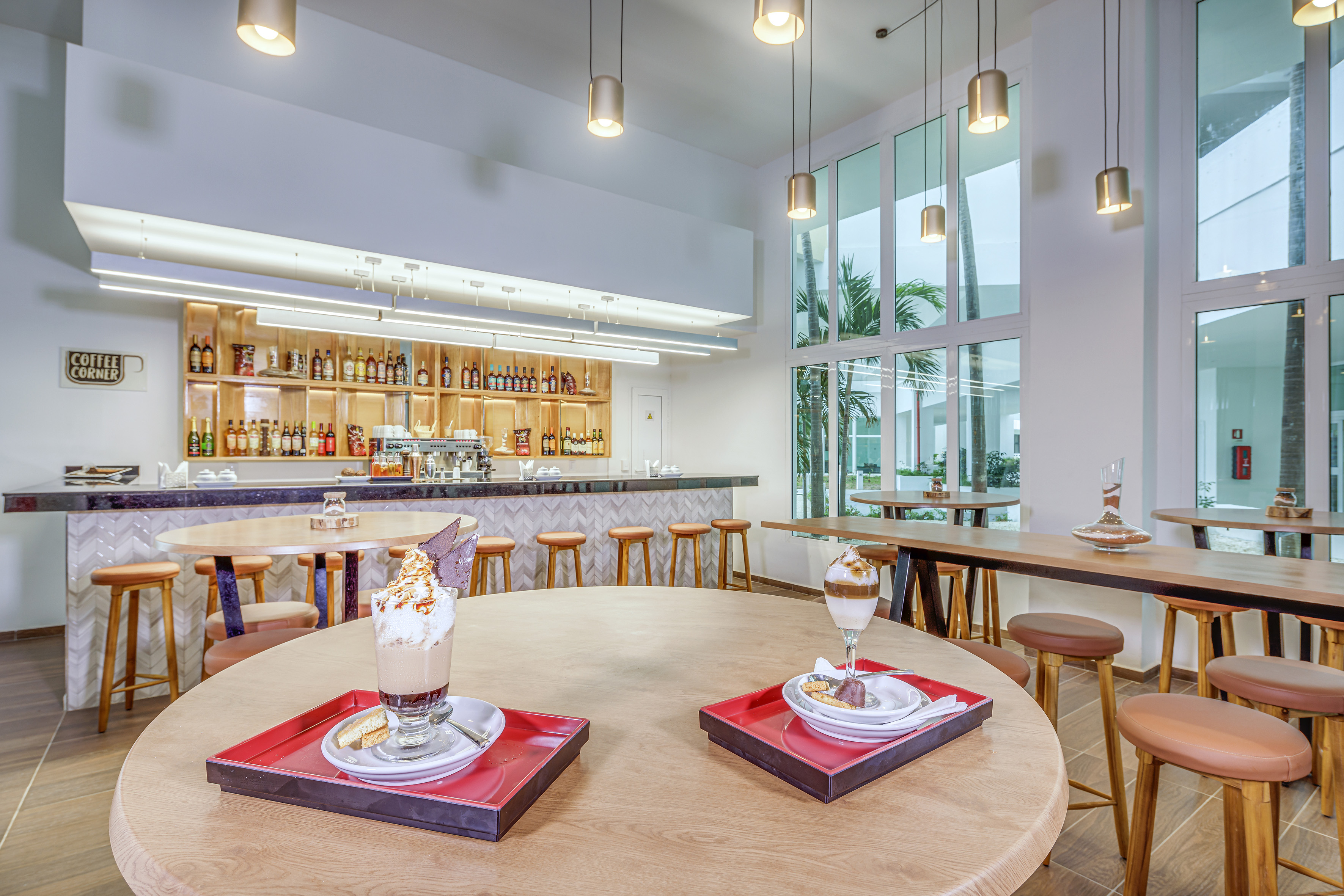 a room with tables and chairs and a bar