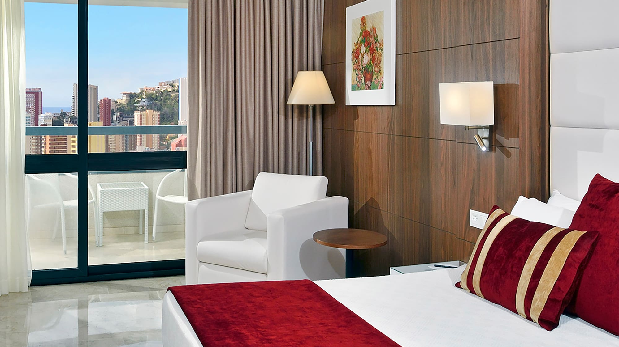 a bedroom with a bed and chairs