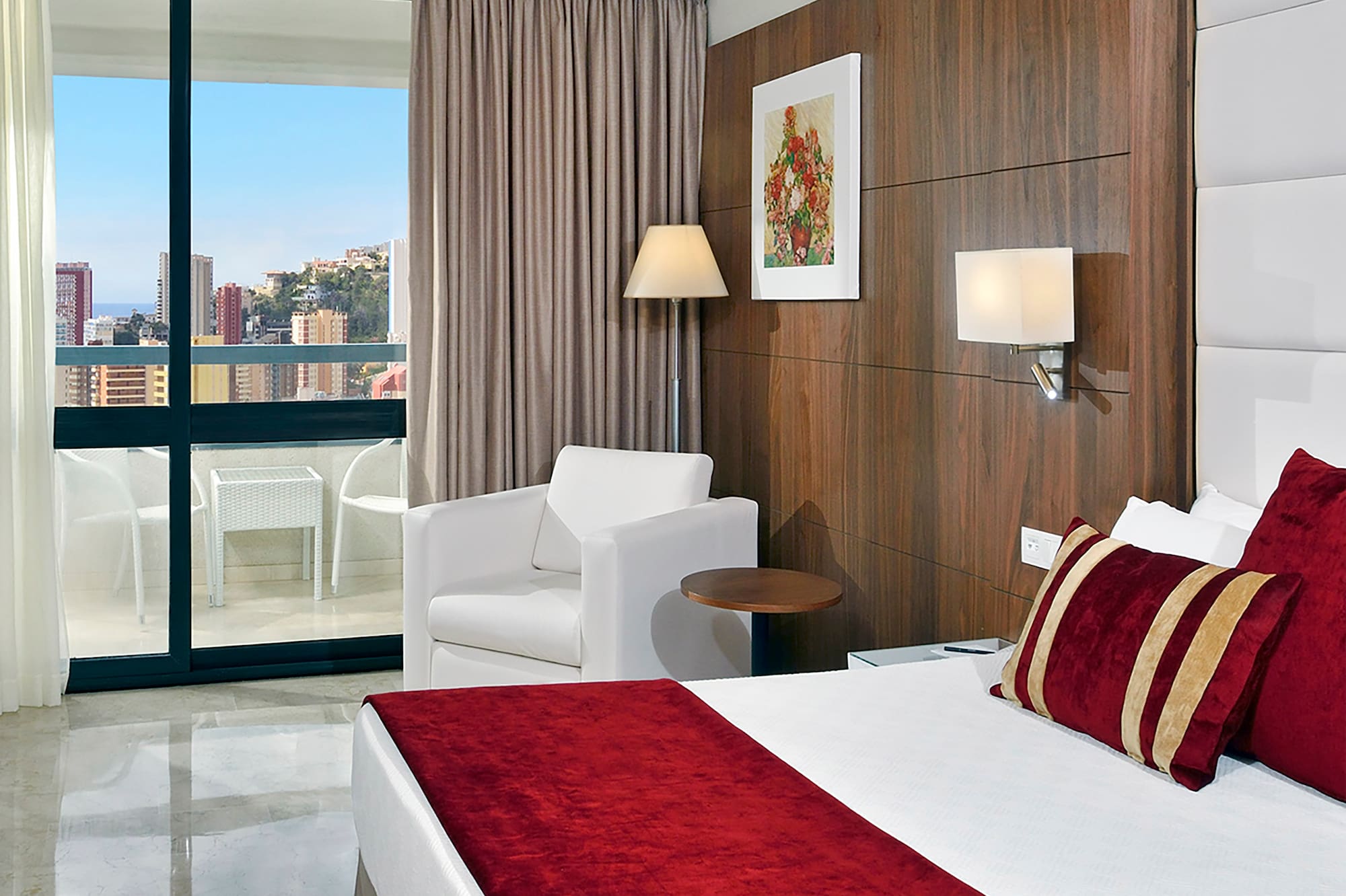 a bedroom with a bed and chairs