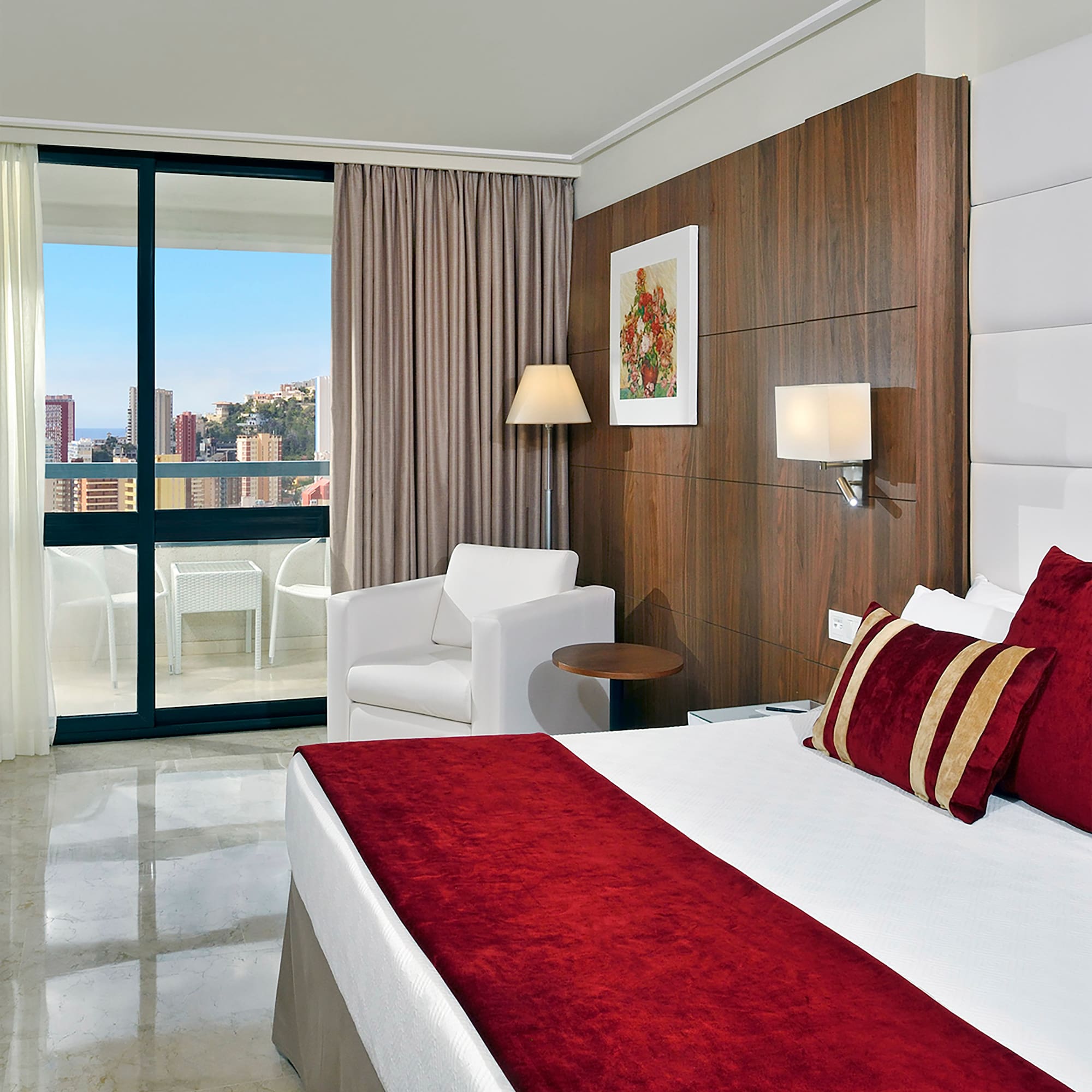 a bedroom with a bed and chairs