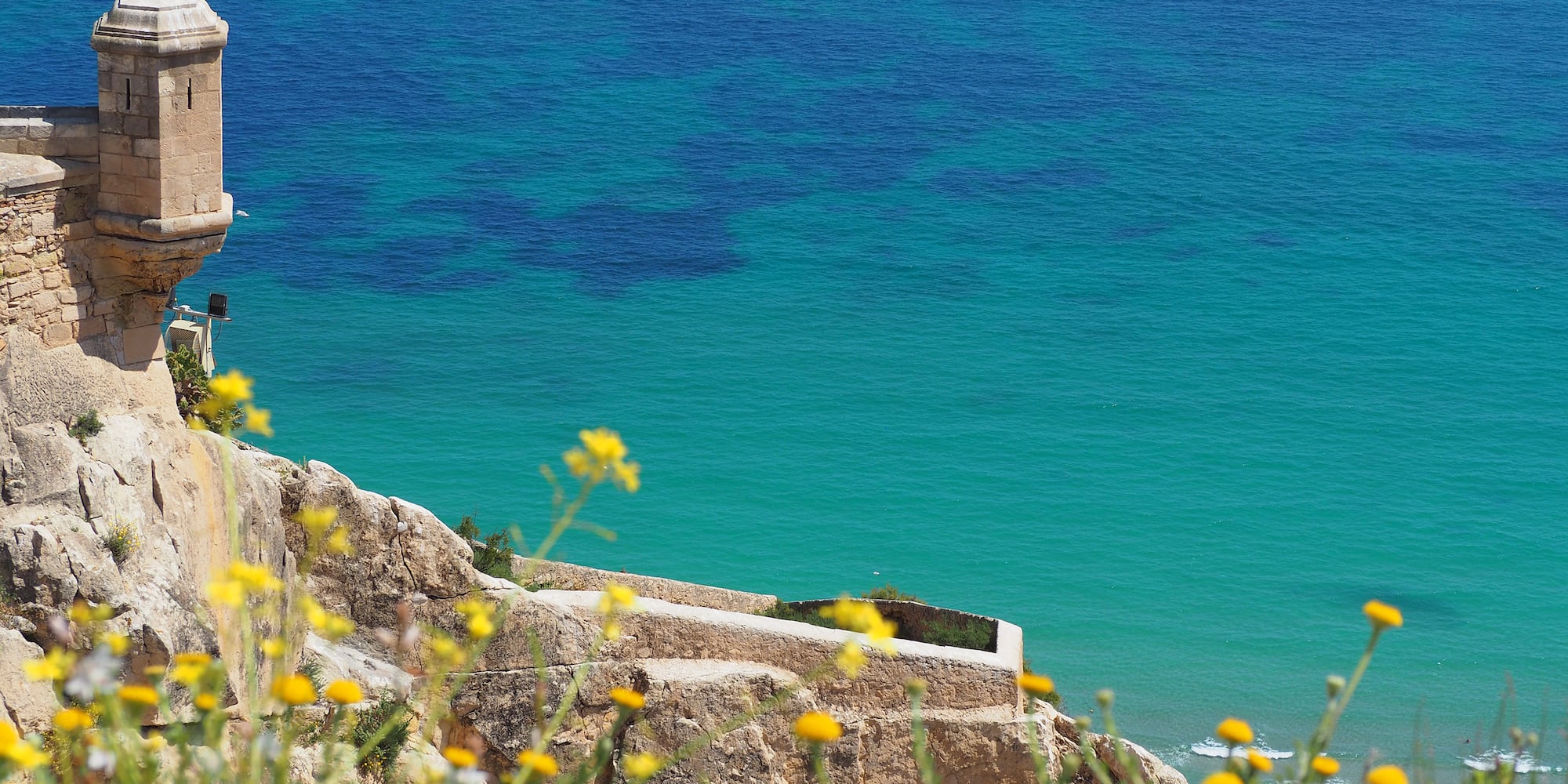 a building on a cliff overlooking a body of water