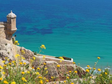 a building on a cliff overlooking a body of water