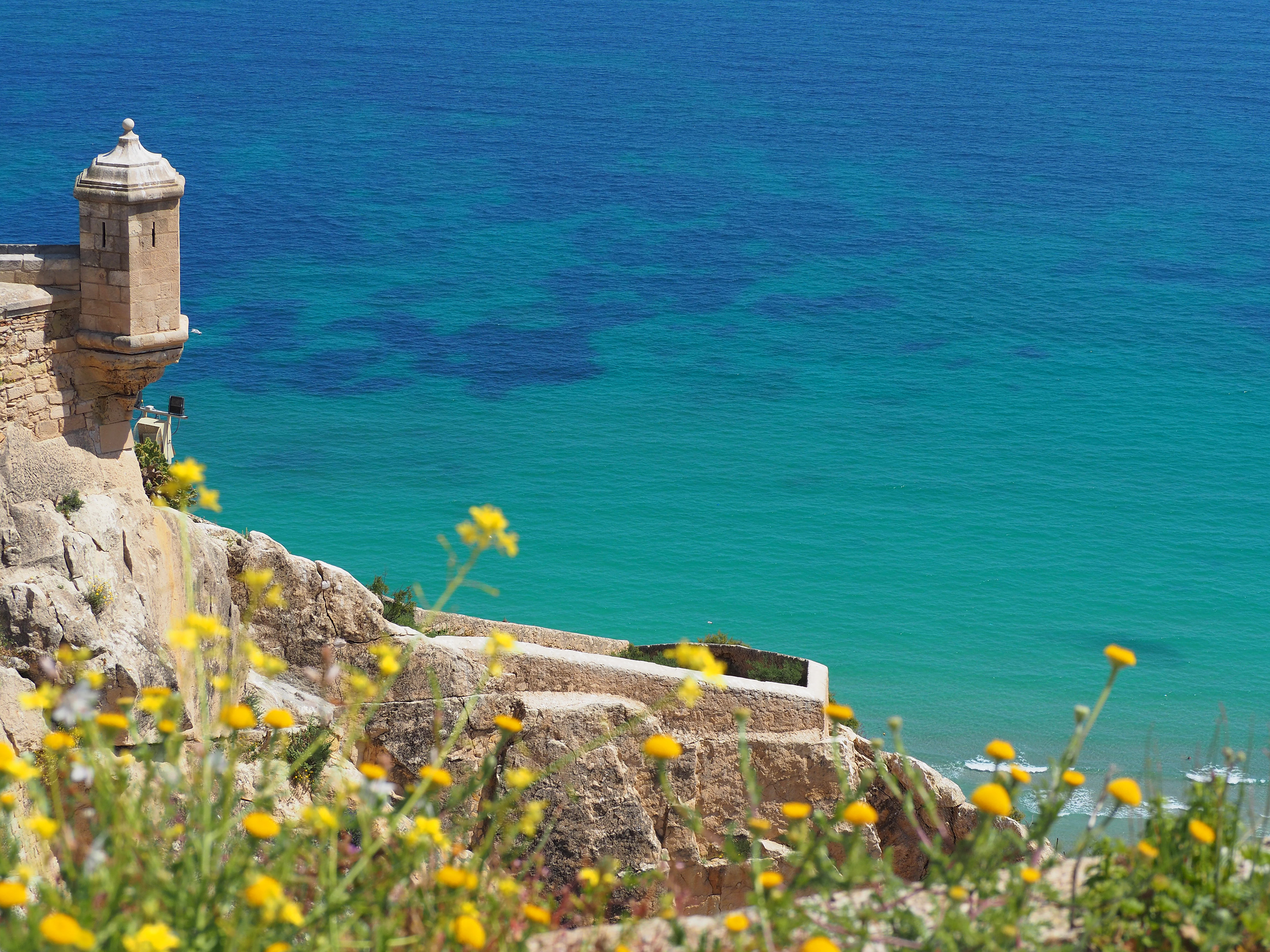 a building on a cliff overlooking a body of water