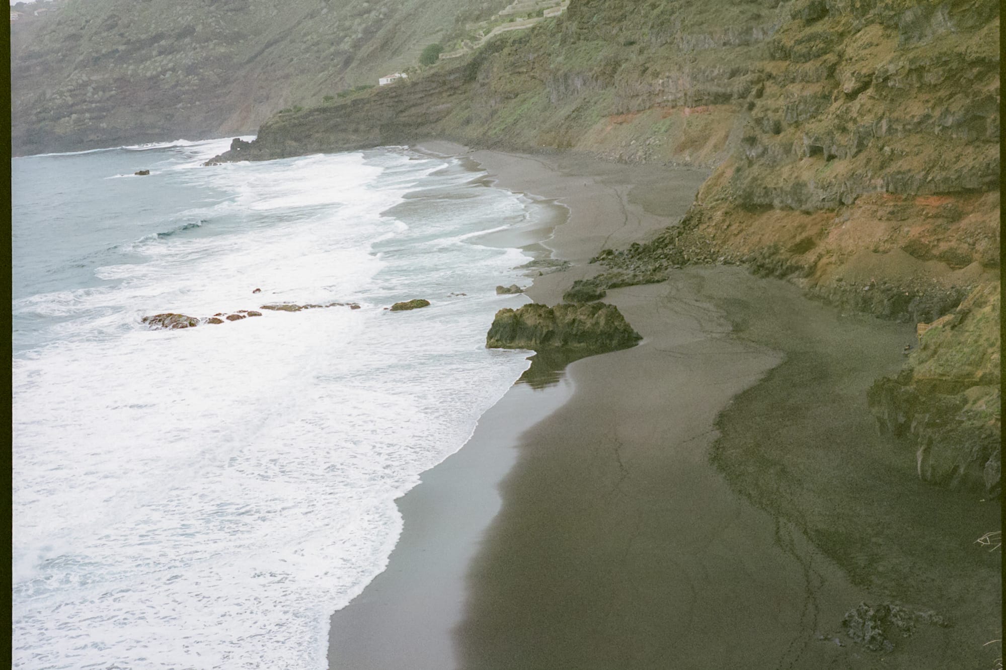 a beach with waves crashing on the shore