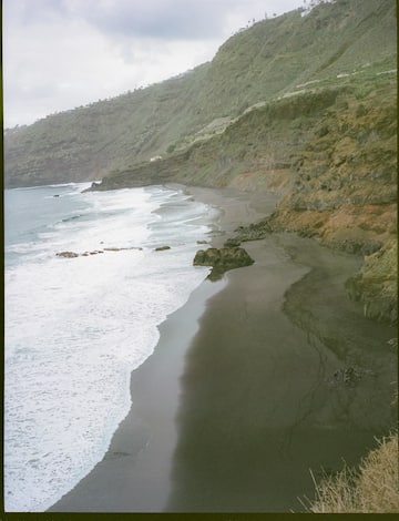 a beach with waves crashing on the shore