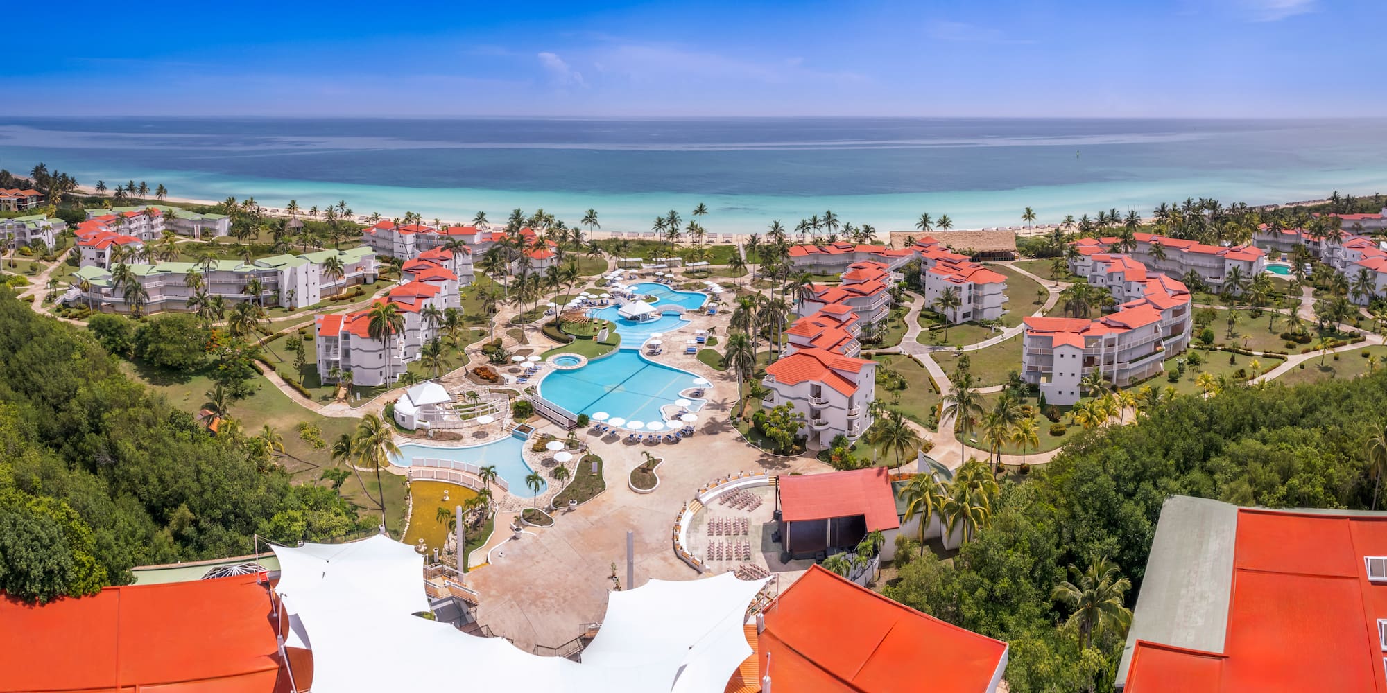 a resort with a pool and a beach