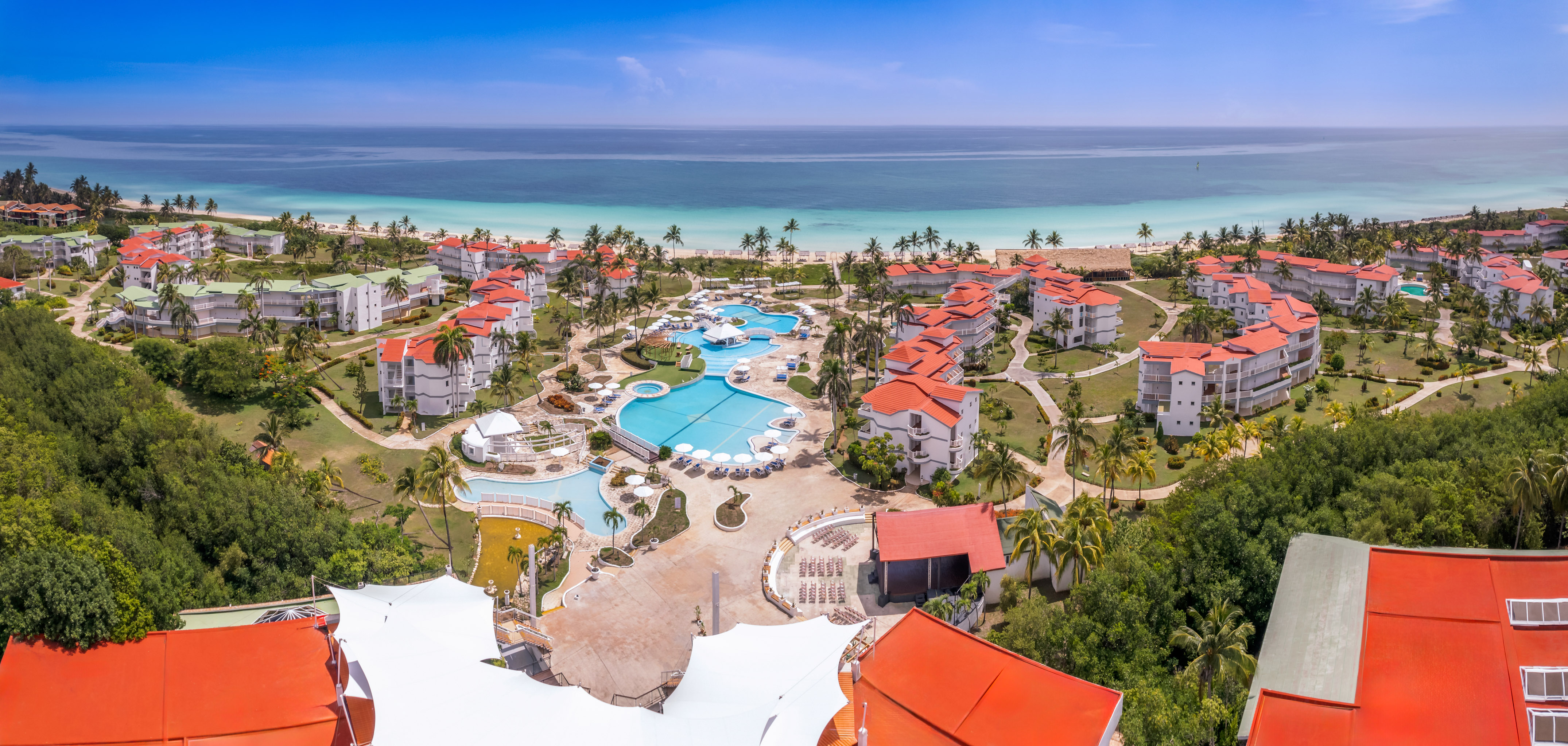 a resort with a pool and a beach