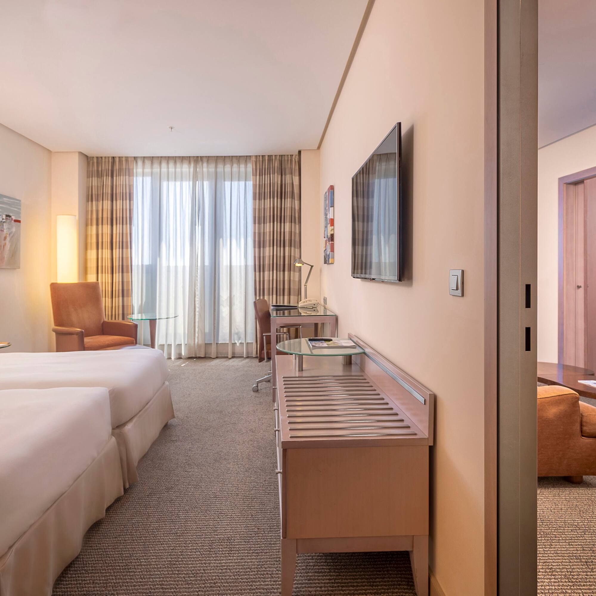 a room with two beds and a television