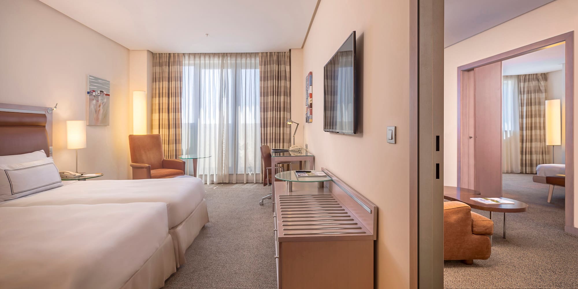 a room with two beds and a television