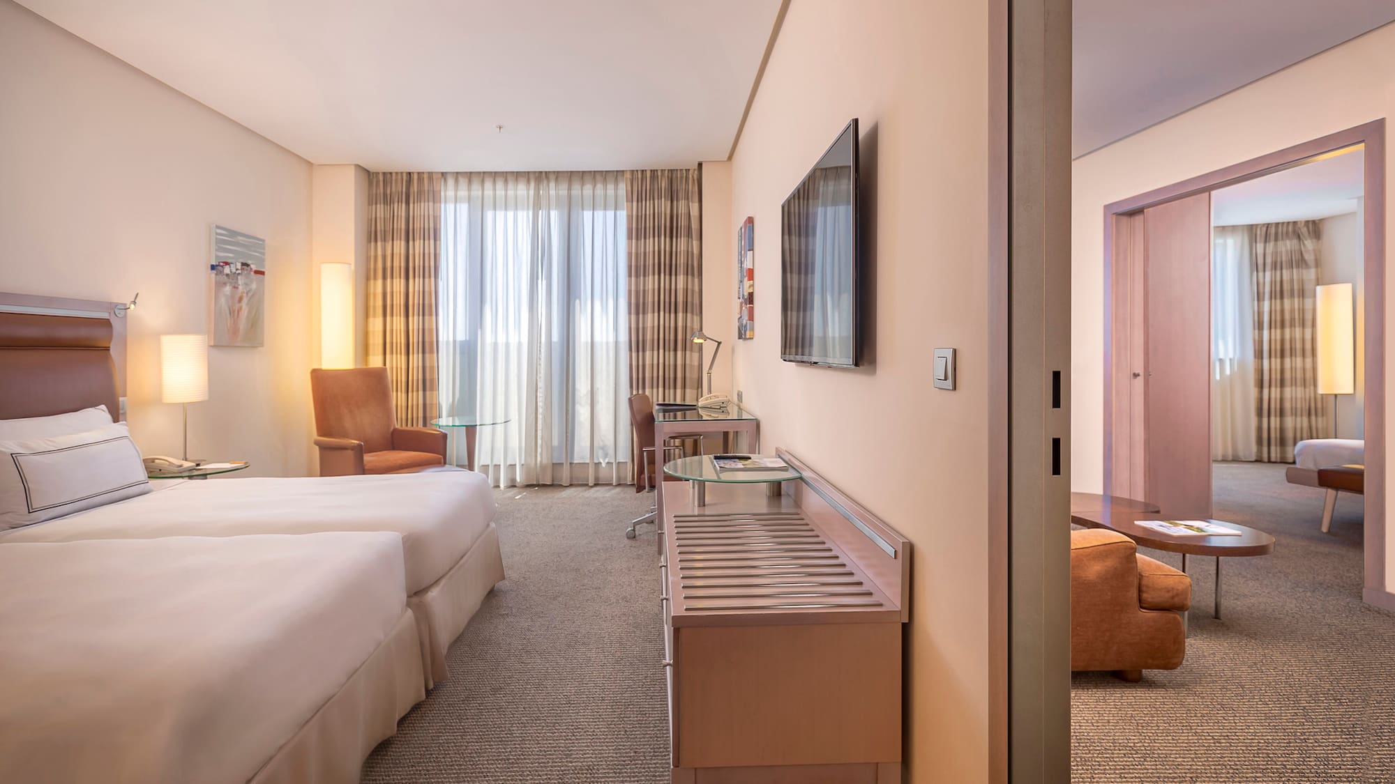 a room with two beds and a television