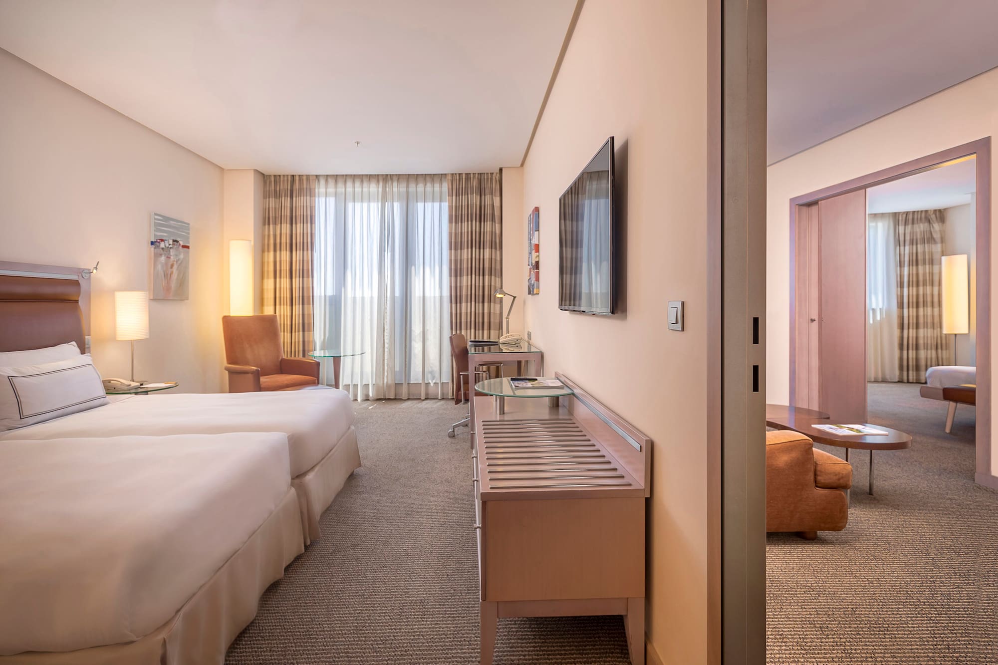 a room with two beds and a television