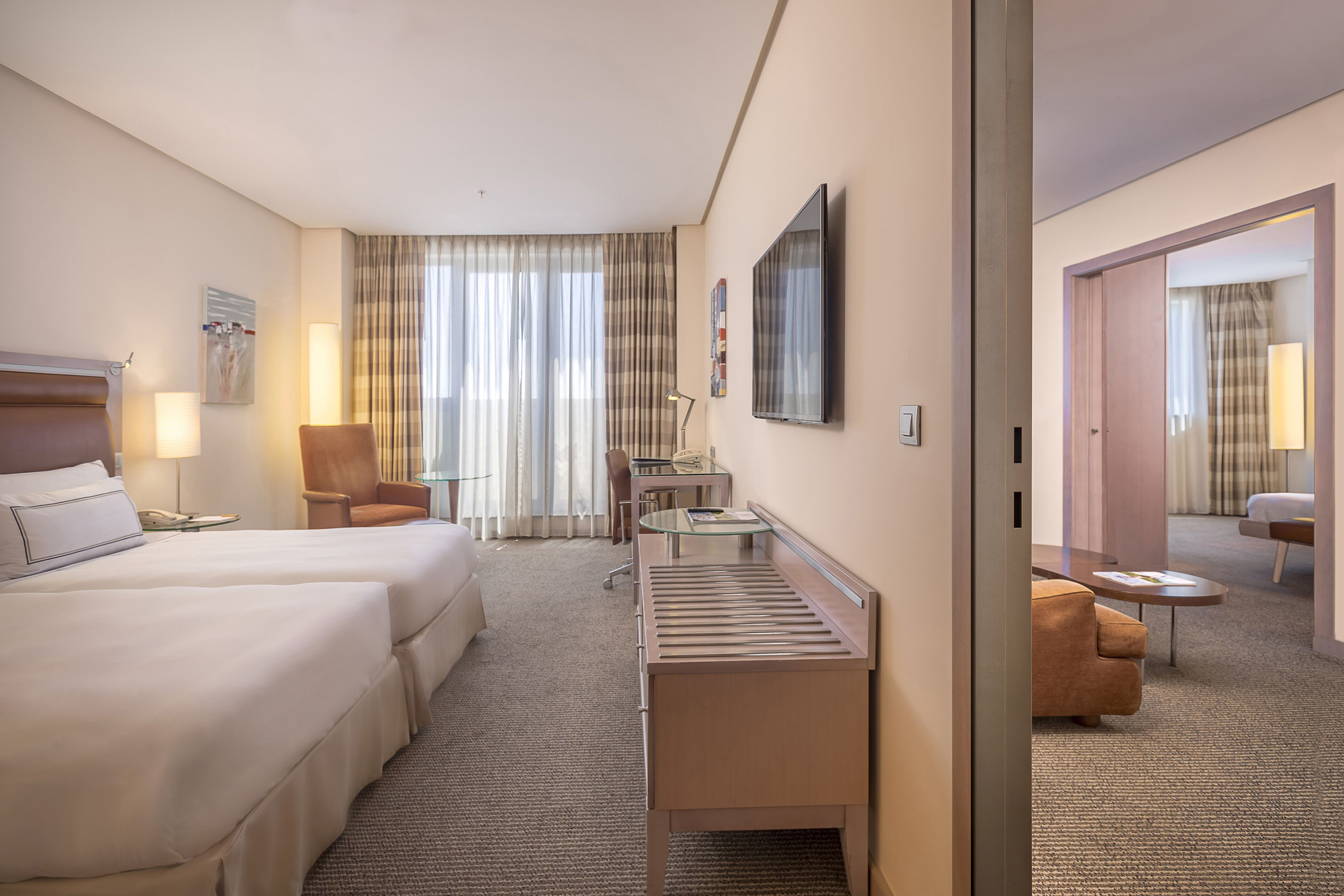 a room with two beds and a television