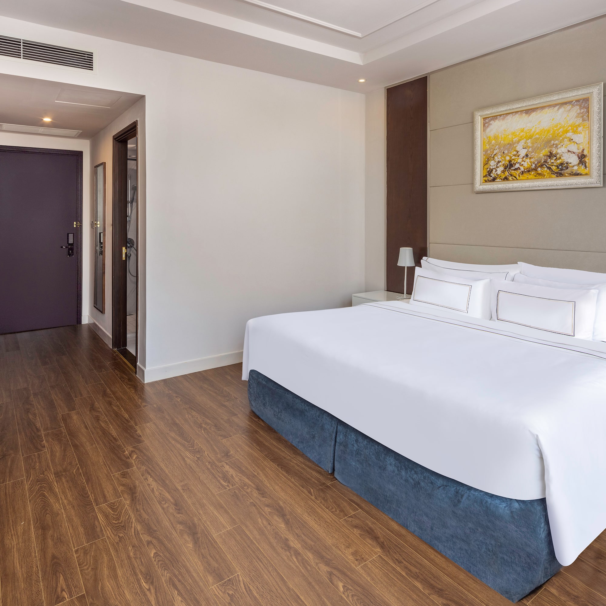 a room with a bed and wood floor