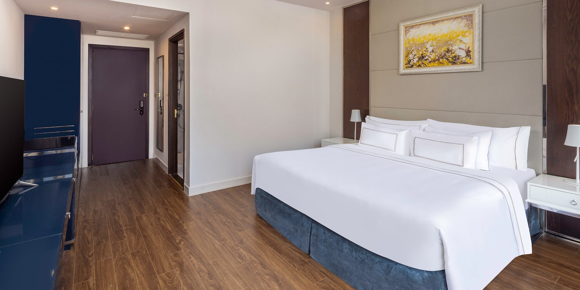 a room with a bed and wood floor