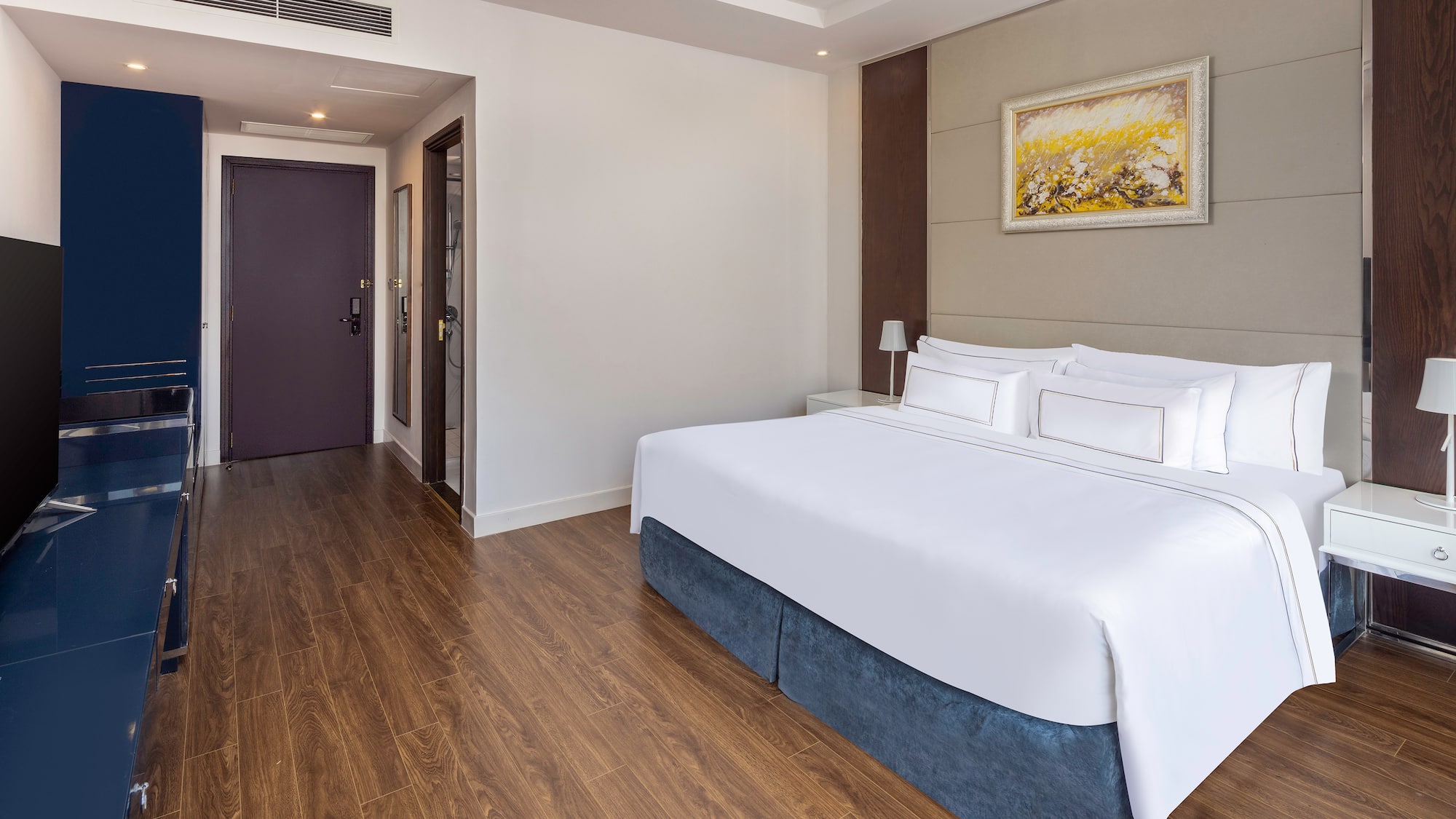 a room with a bed and wood floor