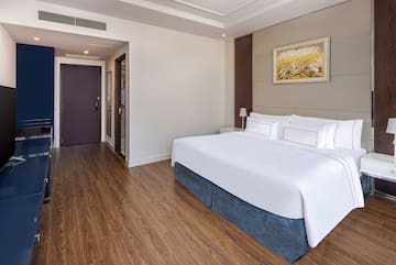 a room with a bed and wood floor