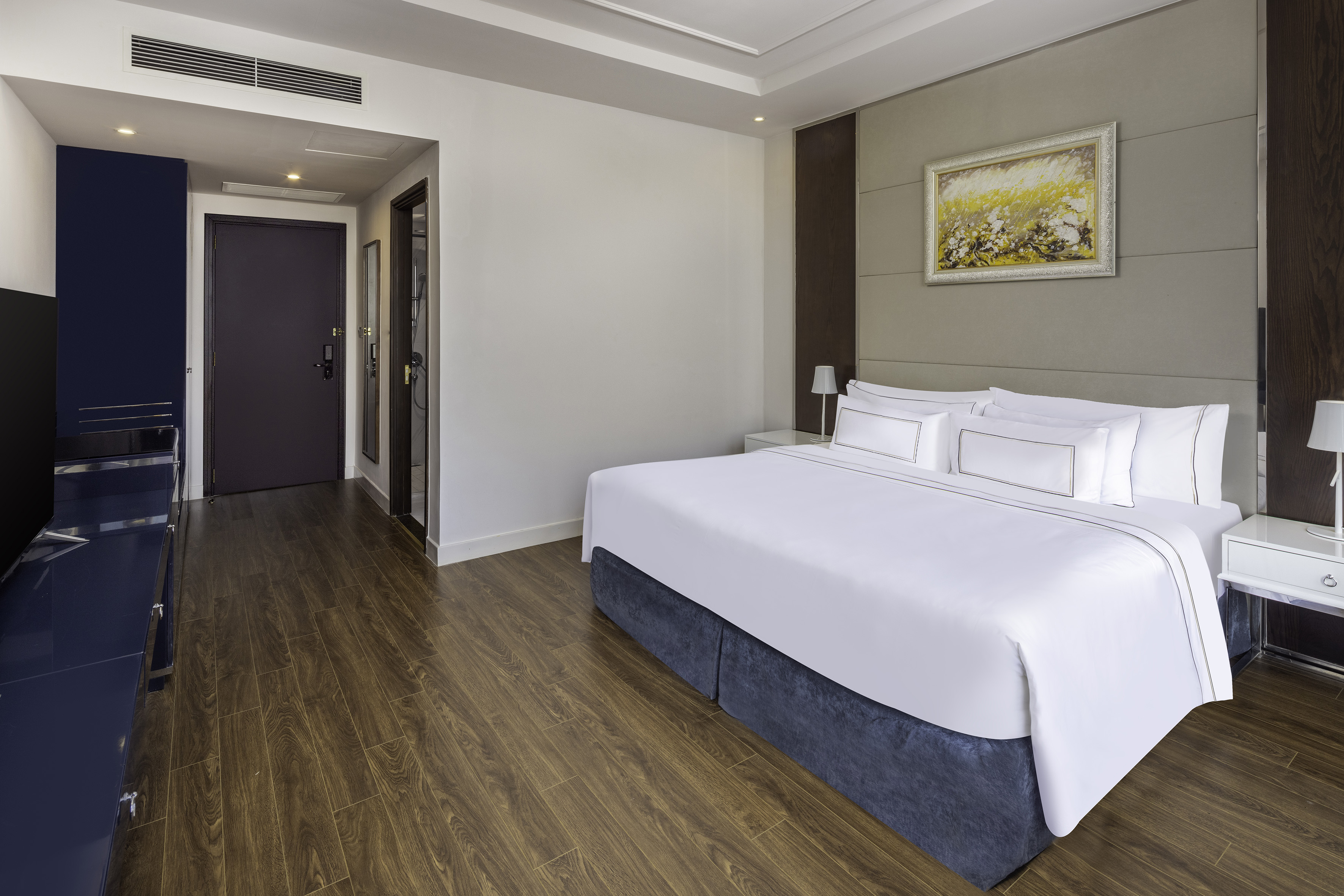 a room with a bed and wood floor