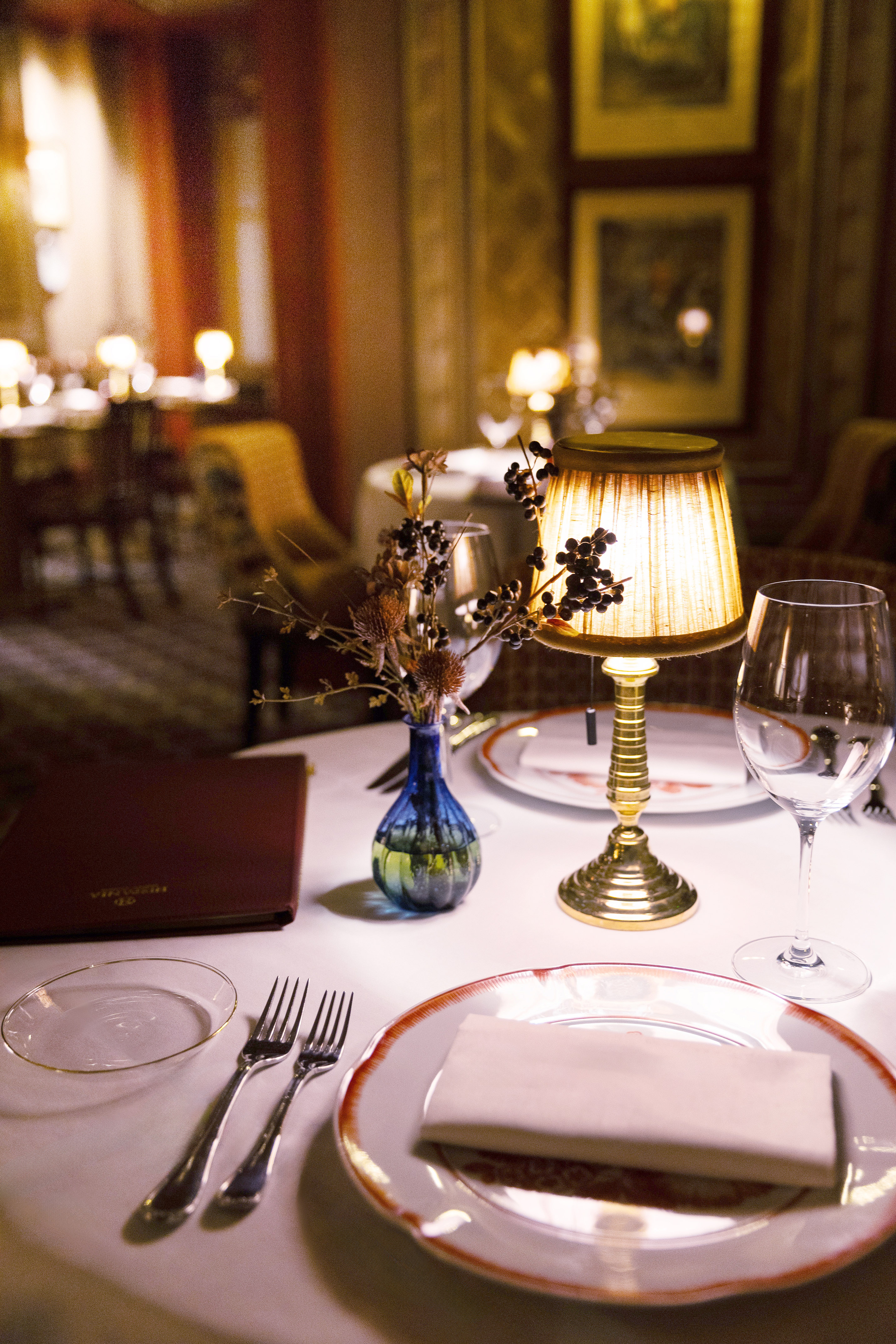 a table with a lamp and glasses