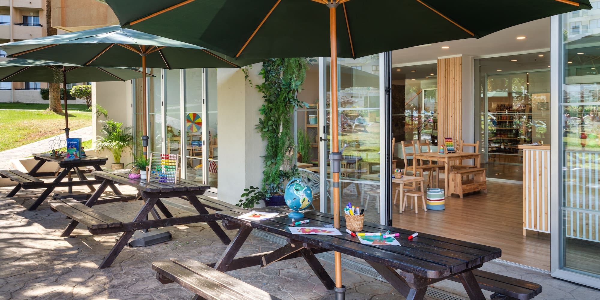 a picnic table and umbrellas outside of a building