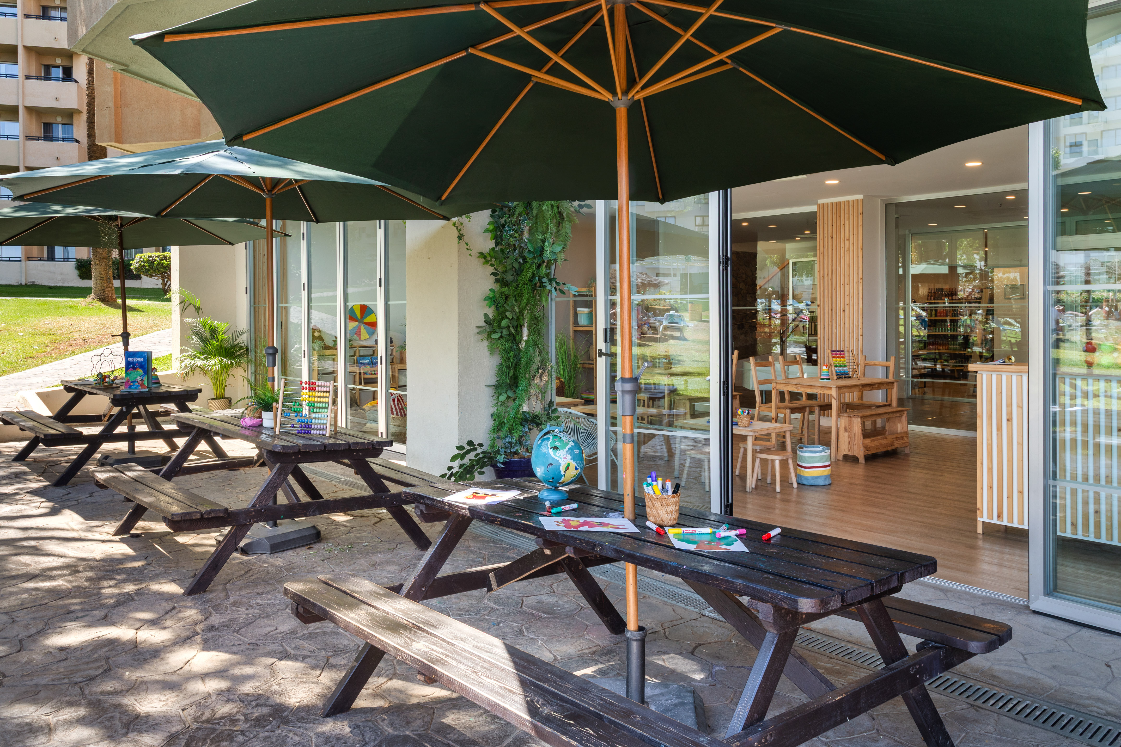 a picnic table and umbrellas outside of a building
