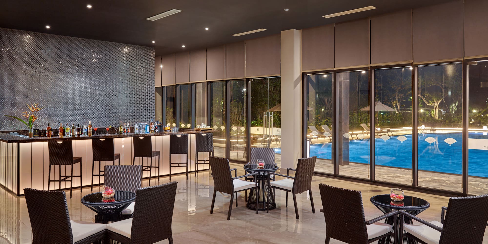 a room with a bar and chairs