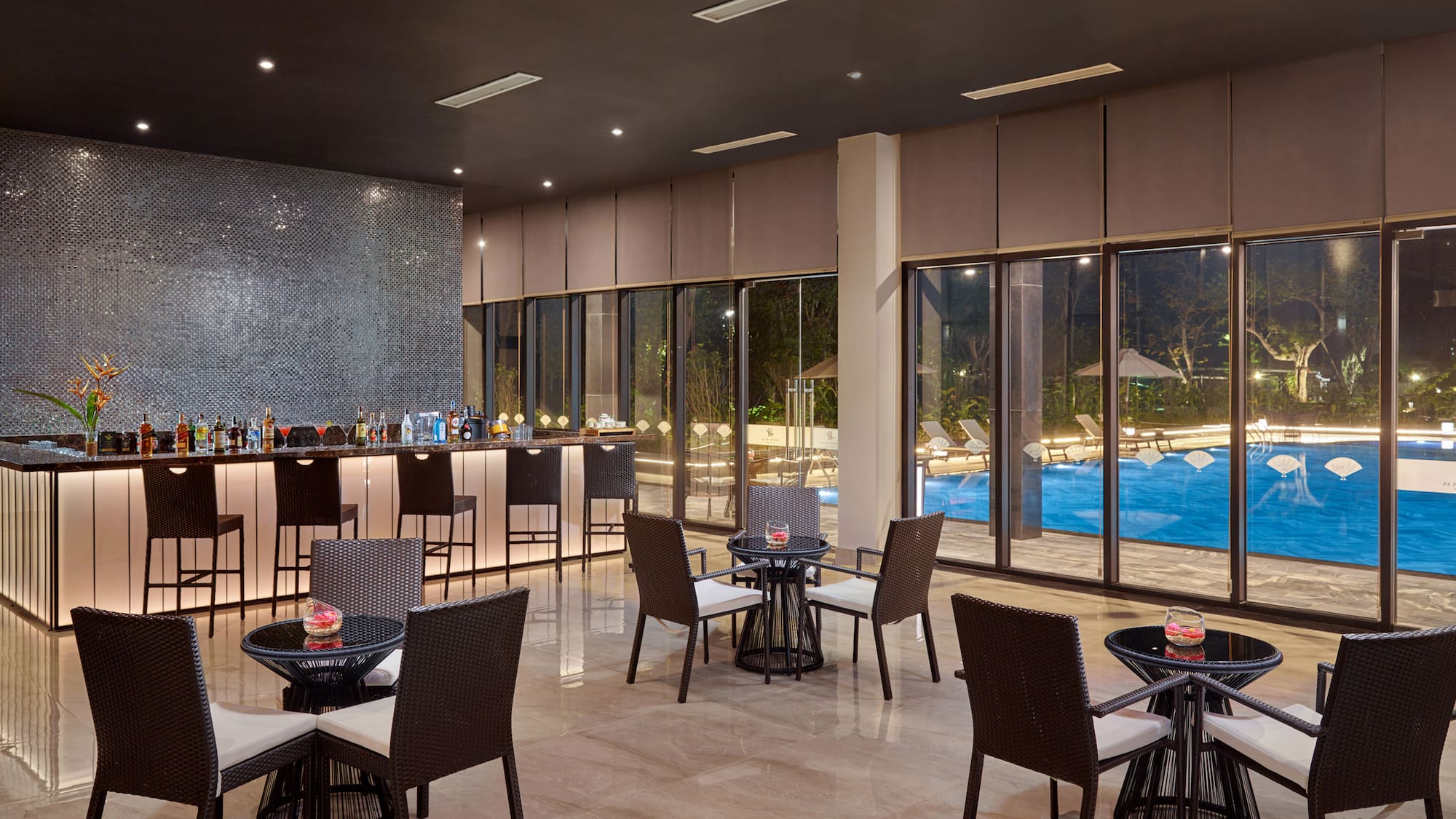 a room with a bar and chairs