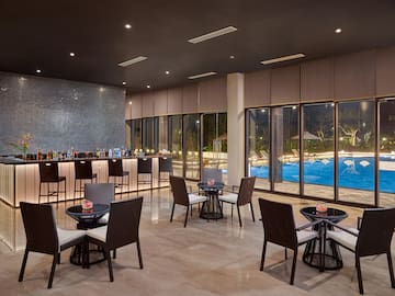 a room with a bar and chairs