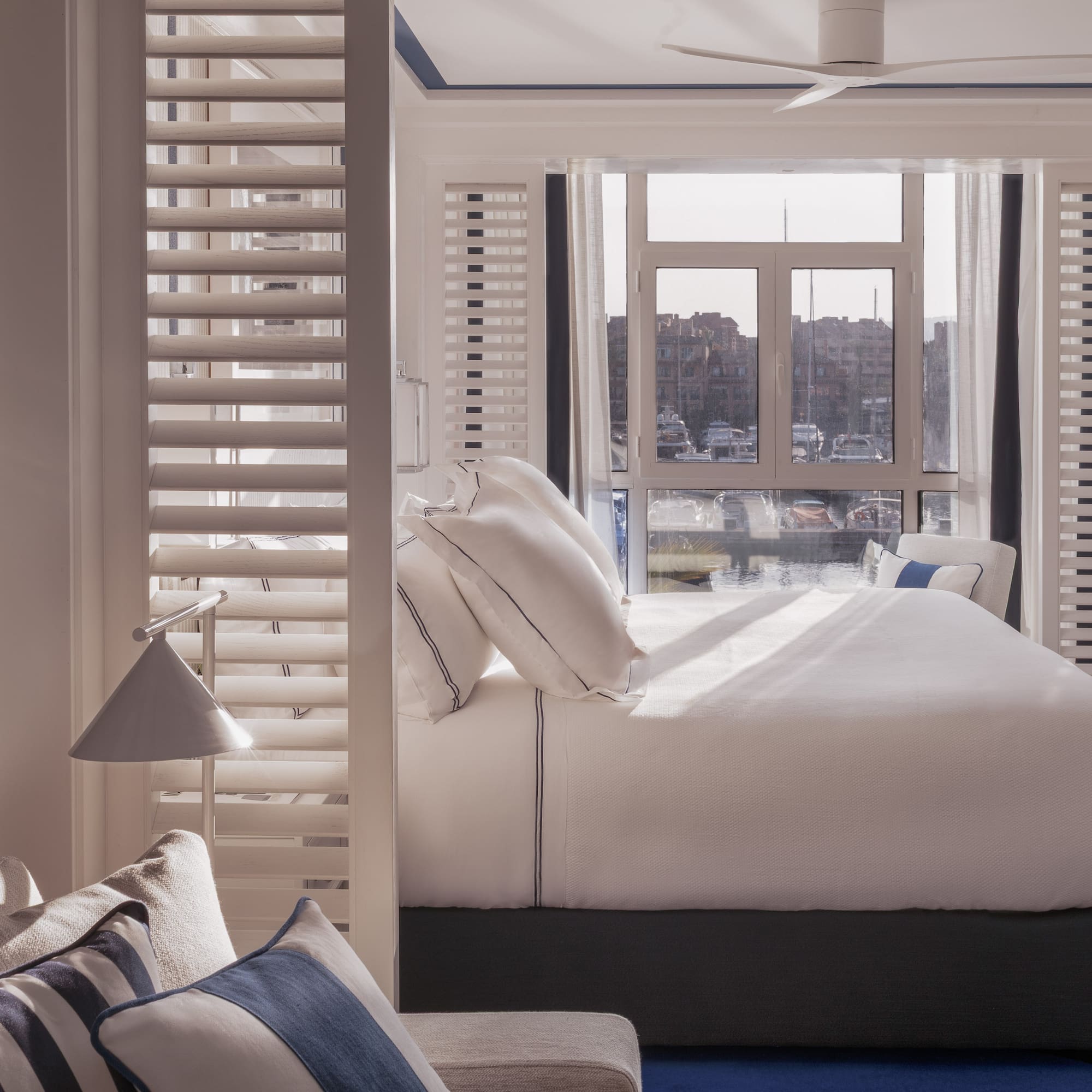 a bed with pillows in a room with a window