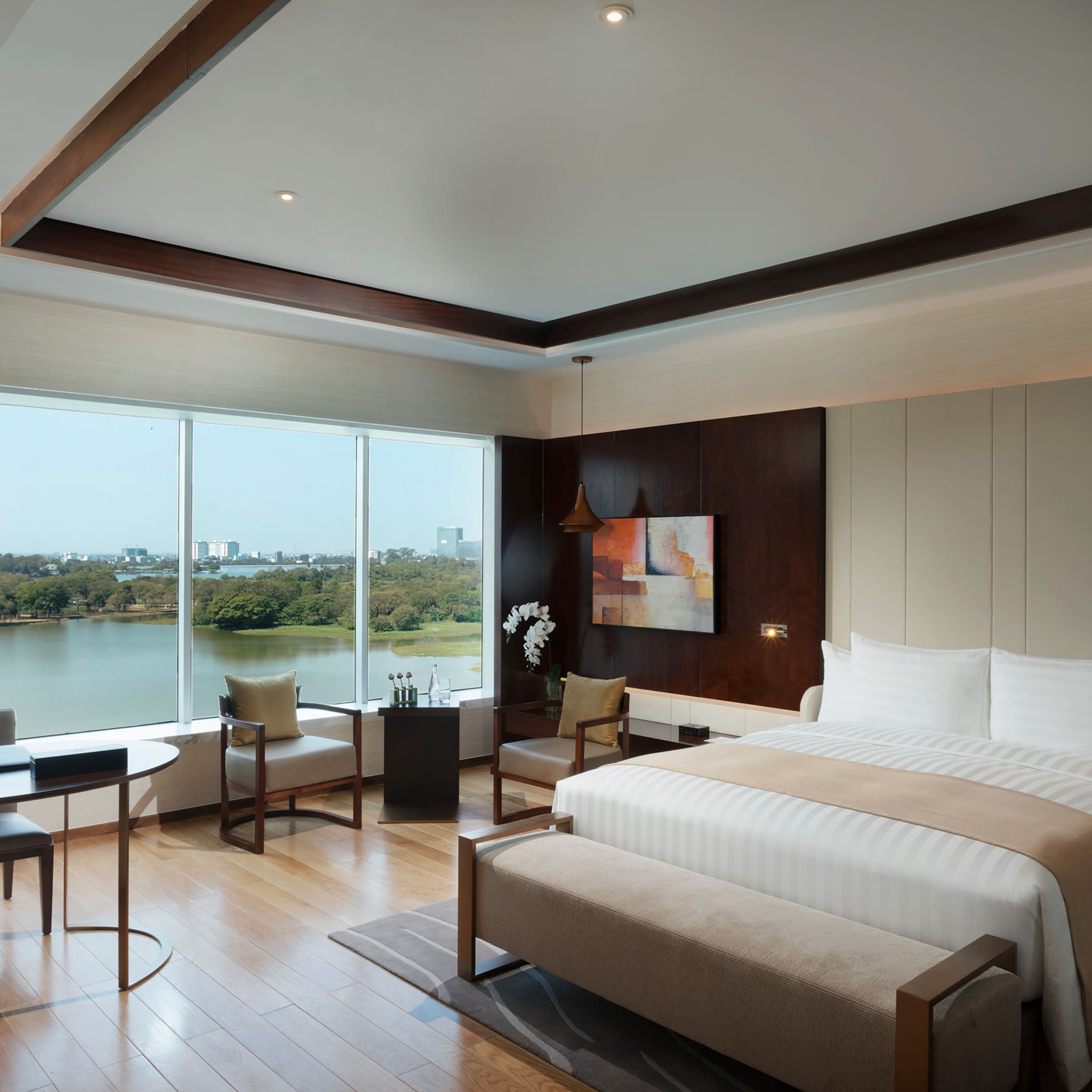 a room with a bed and a table and chairs