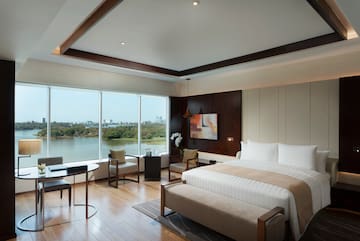 a room with a bed and a table and chairs