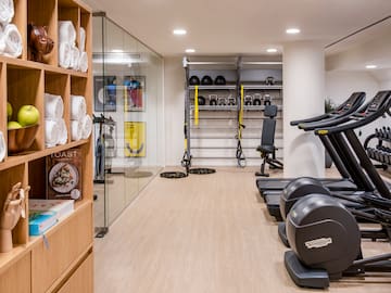 a room with exercise equipment and shelves with other objects