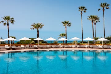 a pool with umbrellas and palm trees