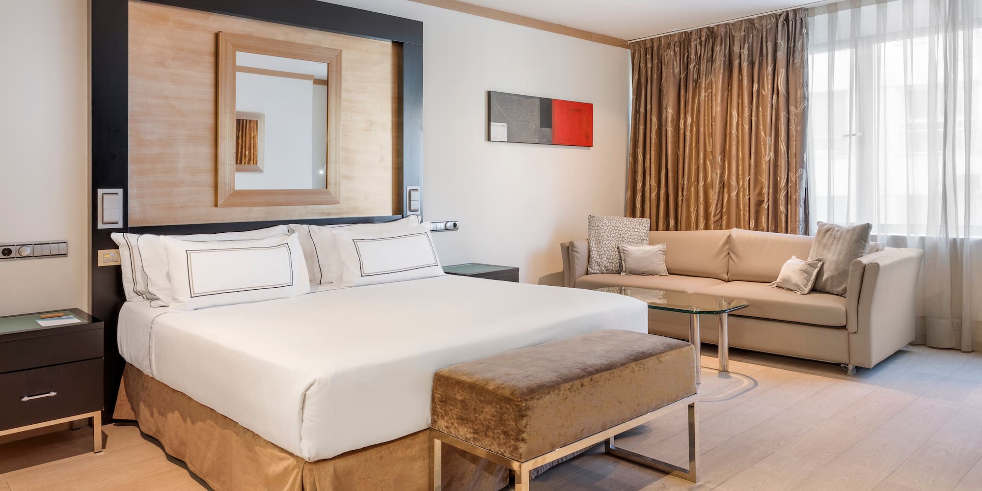 a room with a bed and couches