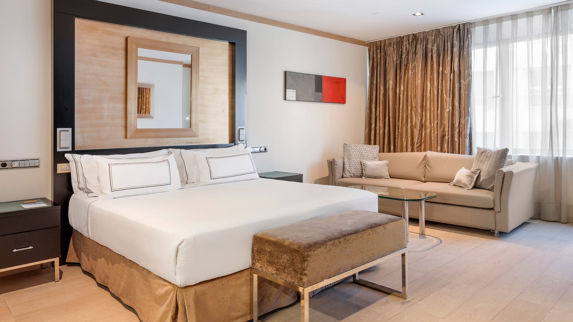 a room with a bed and couches