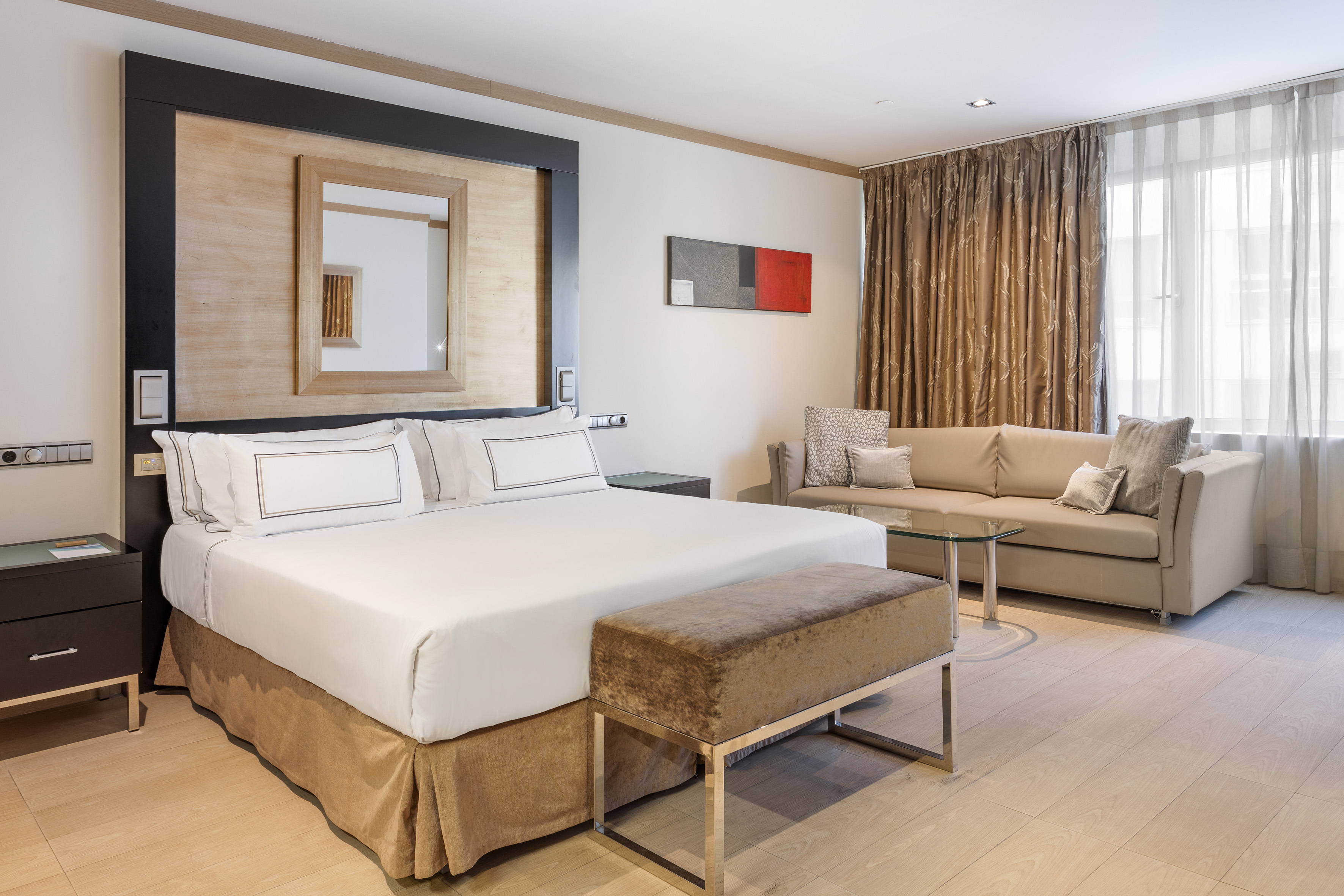 a room with a bed and couches