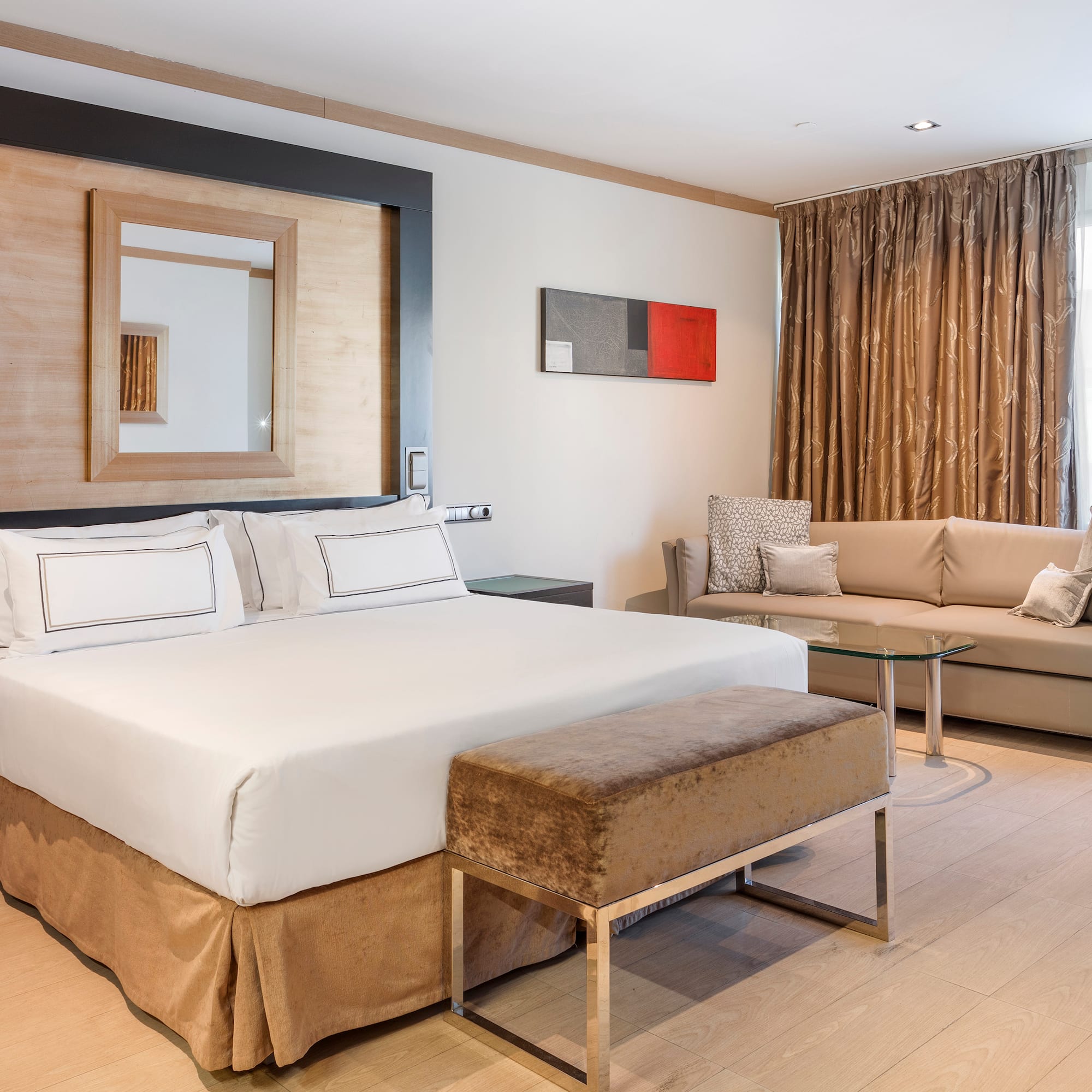 a room with a bed and couches