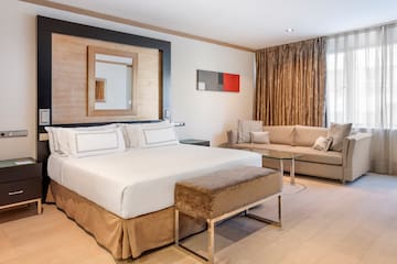 a room with a bed and couches