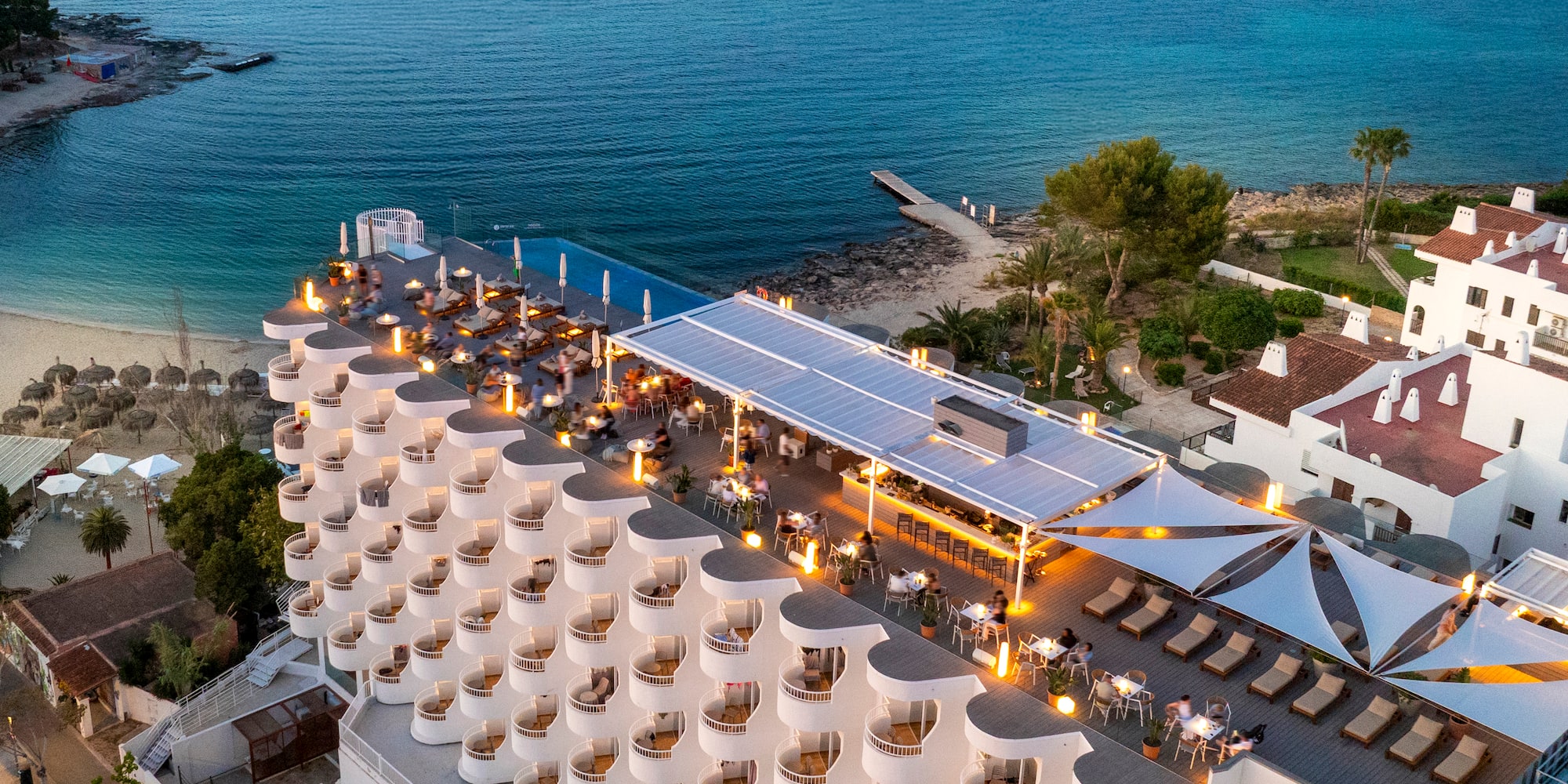 a building with a large roof and a beach