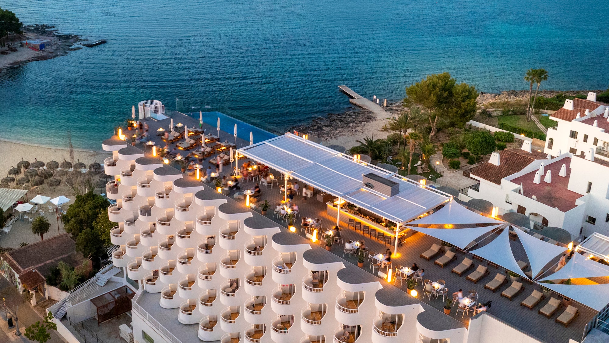 a building with a large roof and a beach