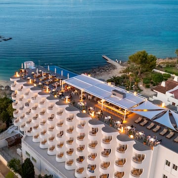 a building with a large roof and a beach
